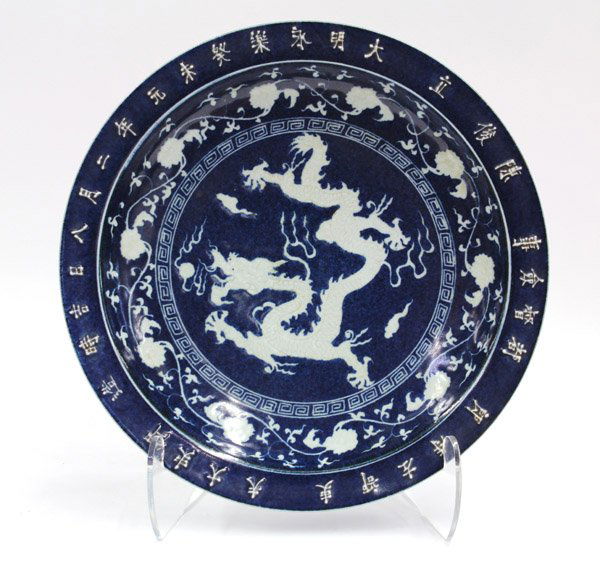 Chinese Large Blue/White Charger w/Dragon: Chinese large cobalt blue decorated porcelain charger, the interior well centered by a white dragon with incised details and reserved on a mottled powder blue ground and set within a white keyfret ban