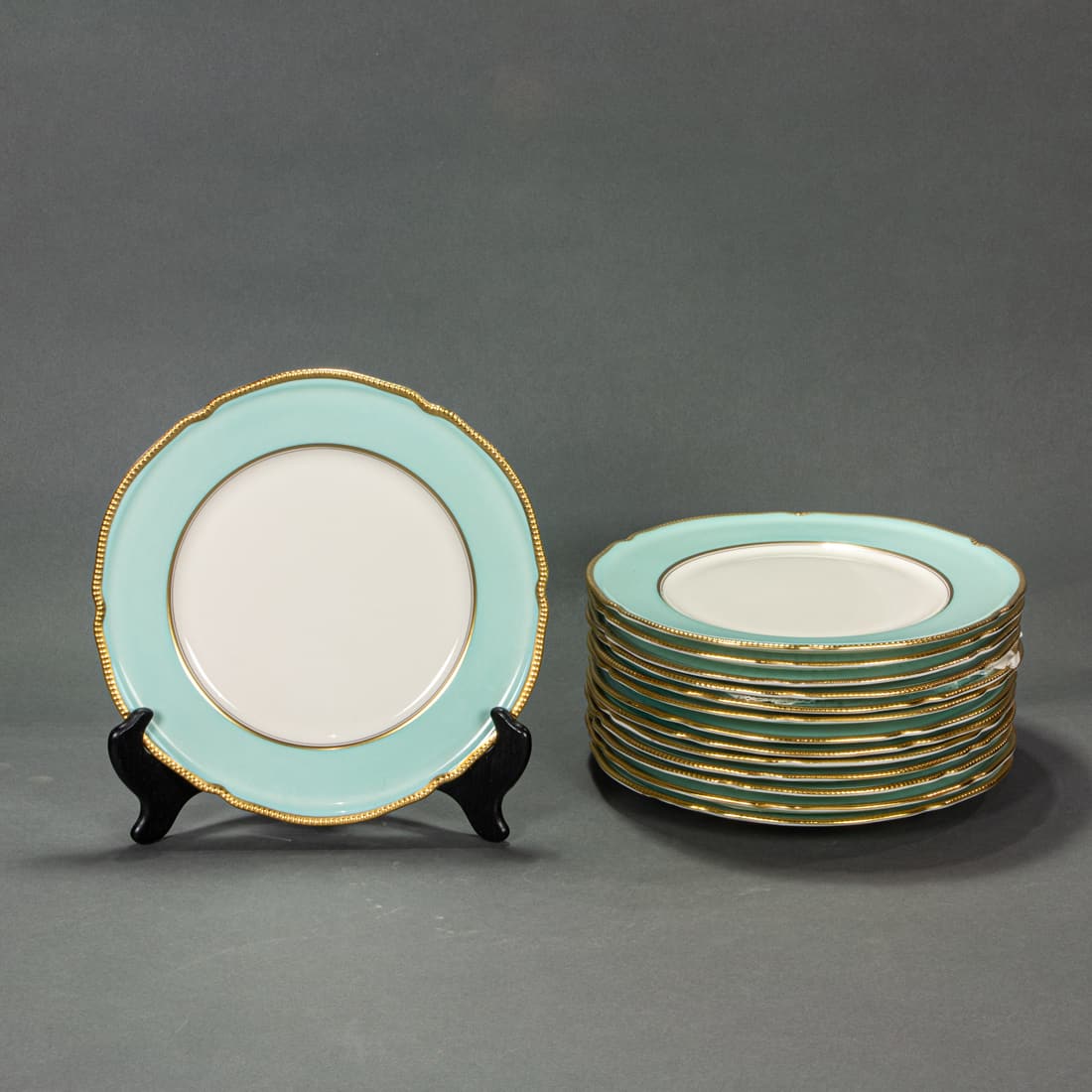 Set of fourteen Castletown China turquoise and ivory plates with shaped gilt rims: Set of fourteen Castletown China turquoise and ivory plates with shaped gilt rims, 10.5"dia. Provenance: Property of a prominent Hillsborough, CA estate