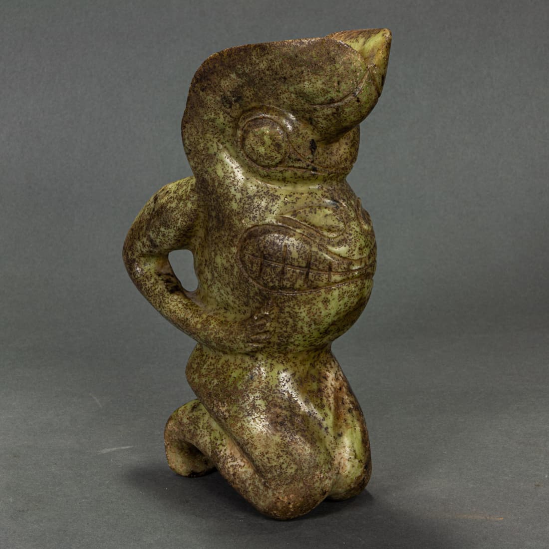 Archastic style green stone kneeling figure (1 of 1)