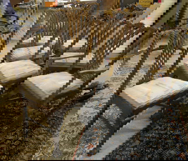 Set of Seven Chippendale Chairs: Set of seven hand carved mahogany sidechairs after Thomas Chippendale, the yoke shapeded carved crestrail with acanthus ears and acanthus center carving over an openwork center splat on a shoe base jo