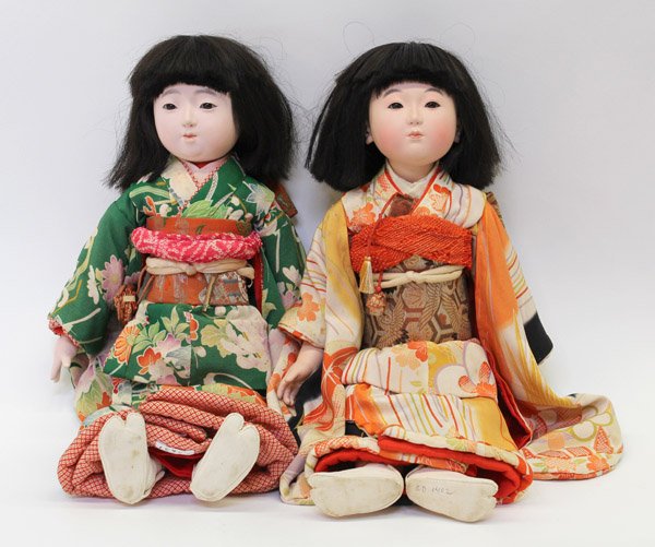 Two Japanese Large Isho Ningyo (Dolls): (Lot of 2) Two Japanese large isho ningyo, 20th century, the first with a painted gofun face, crystal eyes and coiffure of hair, her silk kimono with a floral pattern and secured by an embroidered obi