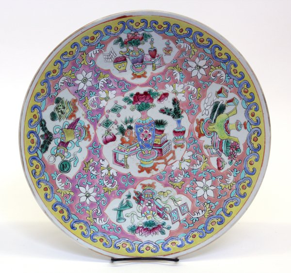 Two Chinese Enameled Porcelain Chargers: (Lot of 2) Chinese polychrome enameled porcelain chargers, the first featuring floral medallions along with the Buddhist Eight Auspicious Symbols scattered on a yellow ground bounded by a pink band br