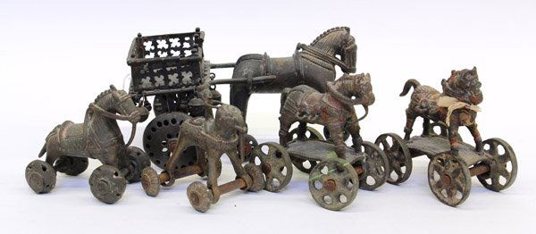 Five East Indian Bronze Pull Toys: (Lot of 5) East Indian bronze/copper alloy pull-toys, the largest of a horse pulling a cart, two of horses riding on a wheeled platform, one of a horse with wheels and the last with a man riding an el