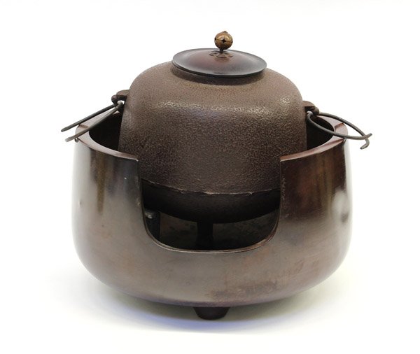 Japanese Iron Kettle and Brazier: (Lot of 3) Japanese tea ceremony patinated bronze braiser of hemispherical shape with a U-shaped opening to the front and set with an iron tripod armature supporting an iron water kettle cast with a t