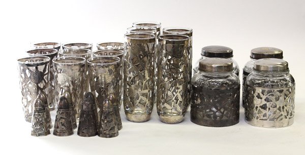 Mexican sterling group: (lot of 20) Mexican sterling silver open work group, consisting of foliage sleeves fitted with five Collins cocktail glasses 7''h, four tumblers 5''h, three Nestle jars 5''h, and eight salts and peppe