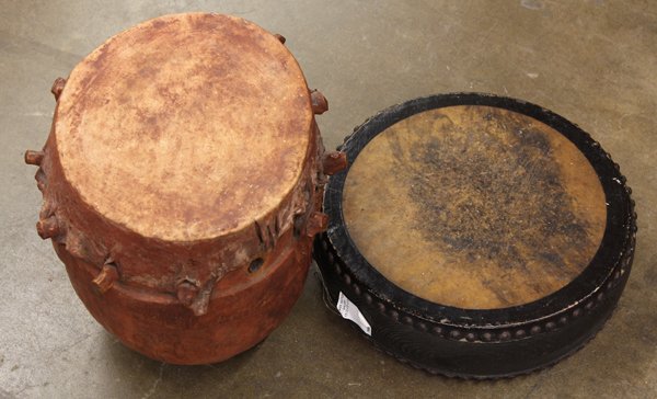 Wood carved drums: Two wood carved drums, the larger believed to originate in German East Africa before WWI Provenance: Lloyd Morain ethnographic collection, Carmel, CA
