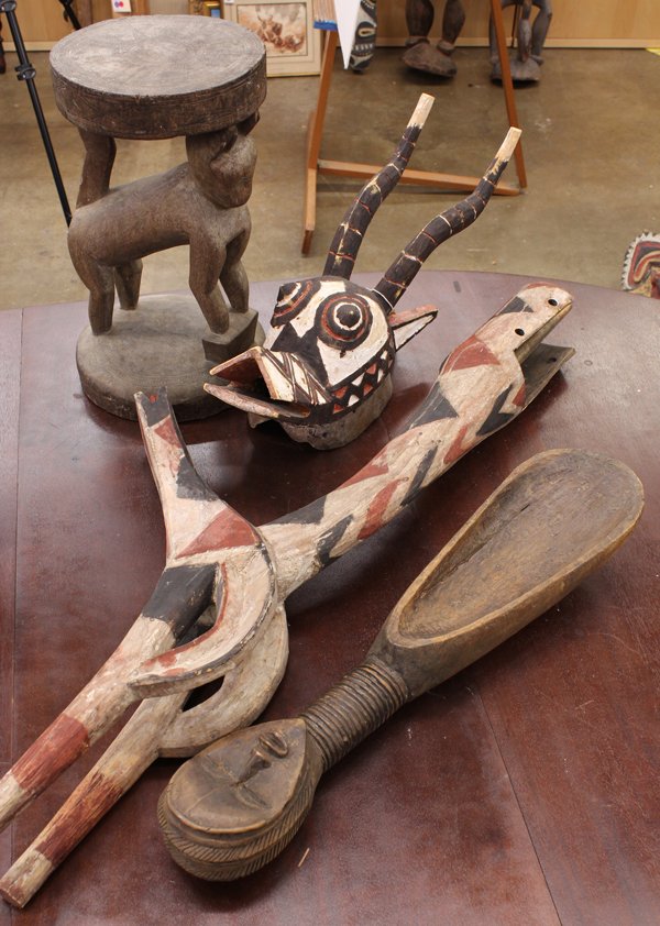 West African carvings: (lot of 4) Three West African decorative animal carvings including a stool supported by a Benin style cat; Bobo tribe antelope mask and giraffe mask; together with a Dan style figural bowl. Provenance