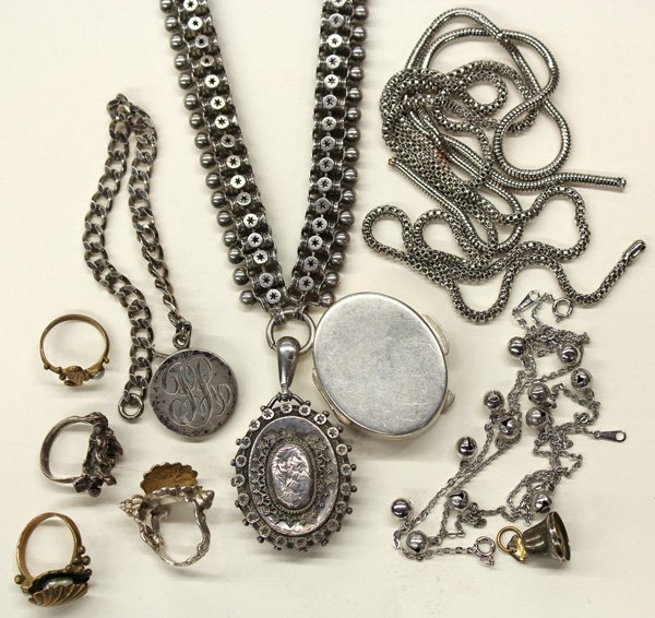 Collection of silver, brass base metal items: Collection of miscellaneous jewelry items of mostly silver plate, base metal, sterling and brass, including; two chains (broken); an ''AVON'' bell necklace and bracelet set; one bell pendant; four rin