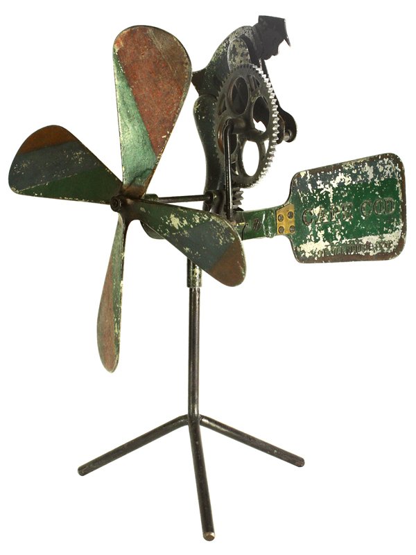 New England whirligig: Jim Ramsdells Toys metal advertising sign, New England circa 1890, the whirligig having a mechanical shopkeeper depicted turning the handle and rotating the gears powered by the propeller, rear tail w
