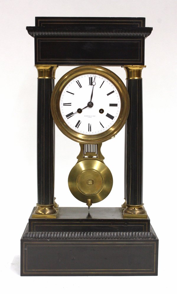 French portico clock: Marshall & Fils portico clock, Paris circa 1890, the ebonized case having a rectangular crest above the enamel dial having Roman markers and centered with the columnar supports accented with gilt meta