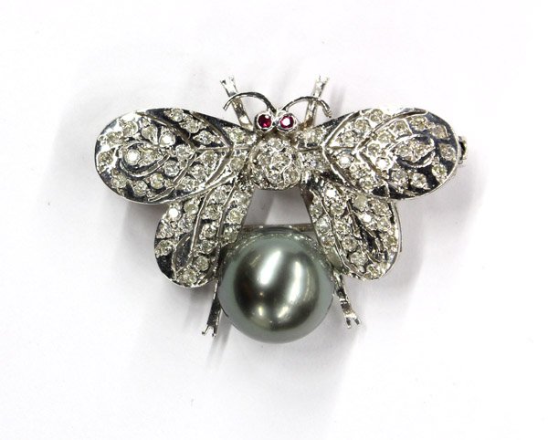 Black pearl diamond ''Butterfly'' brooch: Black Tahitian cultured pearl and diamond ''Butterfly'' brooch; mounted in white gold (stamped ''14K''), featuring an 11.77 mm half-drilled black Tahitian cultured pearl below diamond set wings. Total