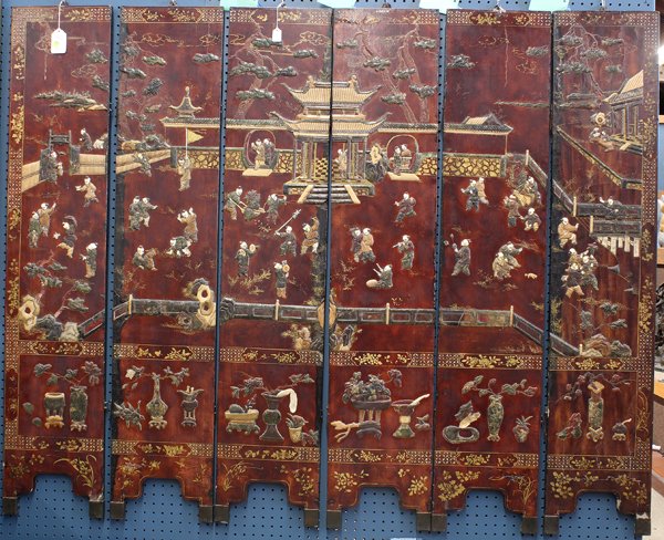 Chinese Overlaid Lacquer Screen: Chinese mid-size overlaid lacquered six panel screen, featuring a continuous scene of children playing on a garden terrace executed in hardstone, soapstone and various overlays above reserves of schol