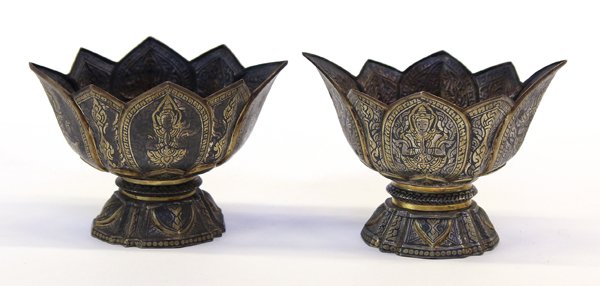 Pair of Thai Silver Niello Dishes: Pair of Thai silver niello dishes, each fashioned as an open eight-petal blossom raised on a waisted pedestal base, the exterior decorated with asparas (celetial beings) amid scrolling leafy foliage, 
