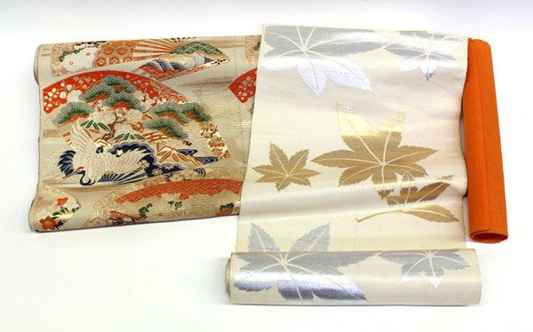 Two Japanese Brocade Obi: (Lot of 2) Japanese silk brocade obi, the first of maple leaves woven in silver and gold on a cream-colored ground, 14''w; the second with multicolored scattered fans of various classic designs (with
