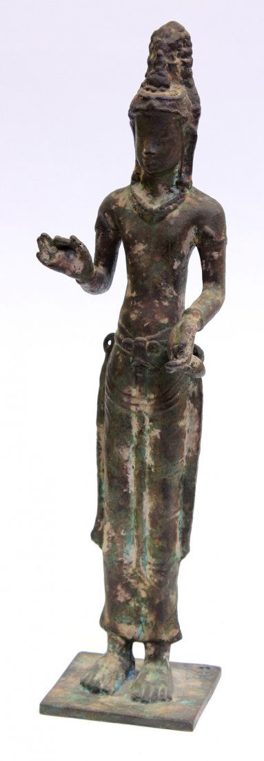 Southeast Asian Patinated Bronze Bodhisattva: Southeast Asian patinated metal figure of Avalokitesvara, the slender bodhisattva standing with his right hand in the abhaya mudra, the other holding an amphora, his face with a gentle expression and
