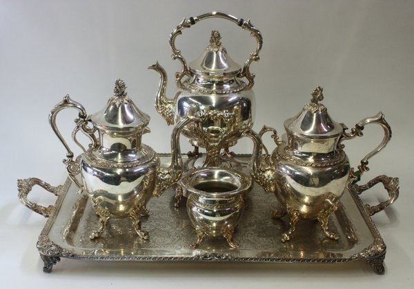 American Silver Plate Holloware: American Silver Plate six piece holloware suite comprising kettle on stand with warmer, coffee pot, tea pot, covered sugar basin, cream jug and waste bowl together with an associated serving tray