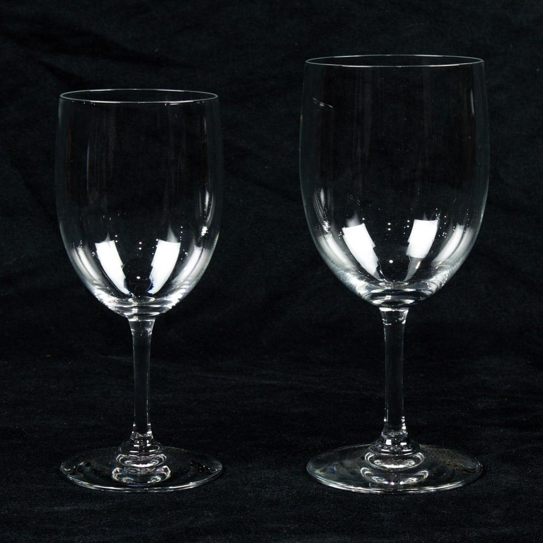 A Baccarat glass suite of stemware in the Montaigne pattern: A Baccarat glass suite of stemware in the Montaigne pattern, each with acid etched factory mark, comprising (10) goblets, 7"h and (11) wine glasses, 6.5"h. [21 total]. Note: Sold to benefit the Assist