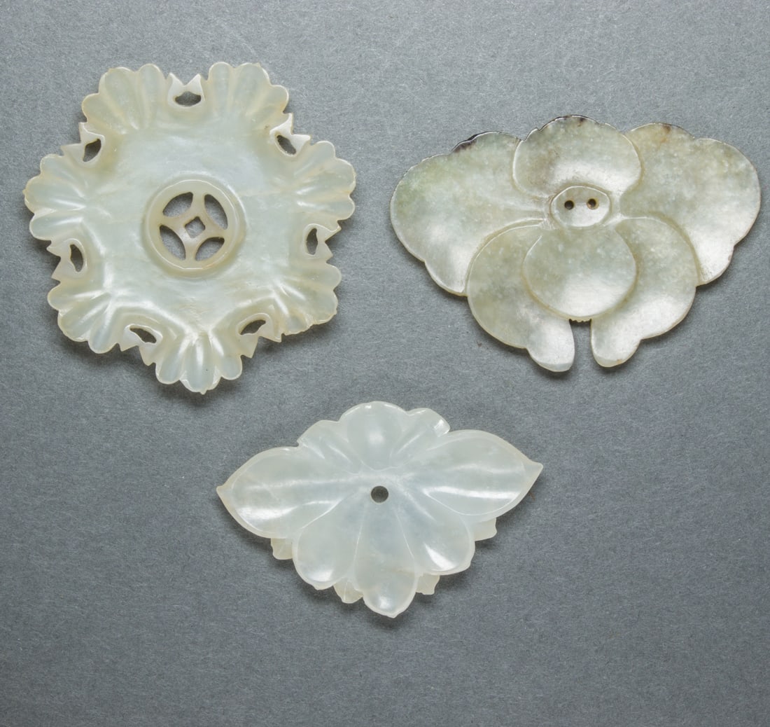 (lot of 3) Chinese jade 'floral' buttons: (lot of 3) Chinese jade 'floral' buttons, from 1.875" to 2.125" wide.