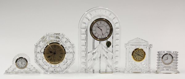 Crystal desk clock group: (lot of 5) Crystal desk clock group consisting of four Waterford examples, each having a cut body with the dial marked Waterford, and etched Waterford, largest 8''h, together with a Baccarat crystal d