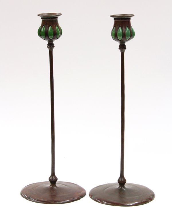 Arts and Crafts Patinated Bronze Candlesticks: Arts and Crafts patinated bronze candlesticks, circa 1920, the dished bobeche above the bulbous reticulated insert having blown glass accents rising on a circular foot marked Tiffany Studios New York,
