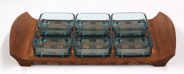 Dansk serving tray: Jens Quistgaard for Dansk, Denmark, serving tray, having six footed condiment bowls inset within the teak tray having a lattice pattern and rising on tapered feet, 2.5''h x 18''w x 10''d