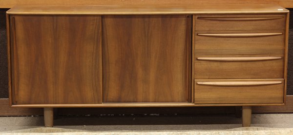 Danish Modern sideboard: Danish Modern sideboard, executed in teak and having sliding doors opening to pull out shelves on one side and rising on tapered legs, 32''h x 72''w x 18''d