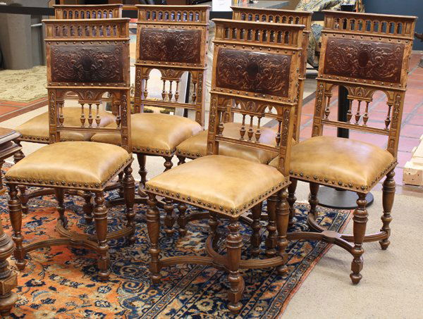 Henri II style dining suite: (lot of 7) Henri II style walnut dining suite circa 1885, the table having a square top above a shaped apron and rising on baluster turned legs conjoined by an H stretcher having columnar supports ter