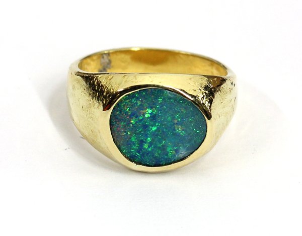 Yellow gold opal ring: Free-form opal ring; mounted in 18K yellow gold, center flush set with (1) free-form tablet cut black opal, weighing 1.20 cts. Total ring weight 6.1 grams. Ring size 6.5
