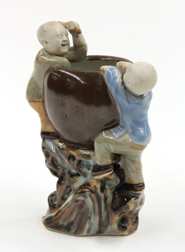 Chinese Porcelain Water Coupe, Children and Jar: Chinese glazed porcelain figural water coupe, fashioned with a pair of boys climbing onto the sides of a large brown glazed jar, and one youngster in glazed celadon robe in contrast with a biscuit fac
