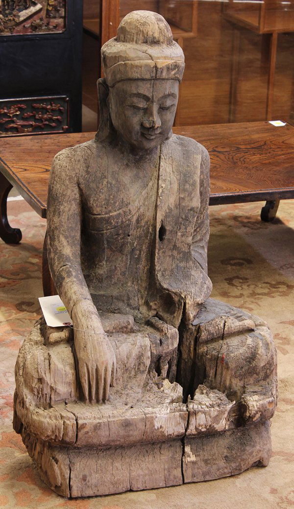 Asian Wooden Buddha: Asian wood carving of a Buddha, possibly 19th Century, seated on a plinth with hand in bhumisparsa mudra while in a monk's robe draped over the left shoulder (loss of one hand), 30.75''h