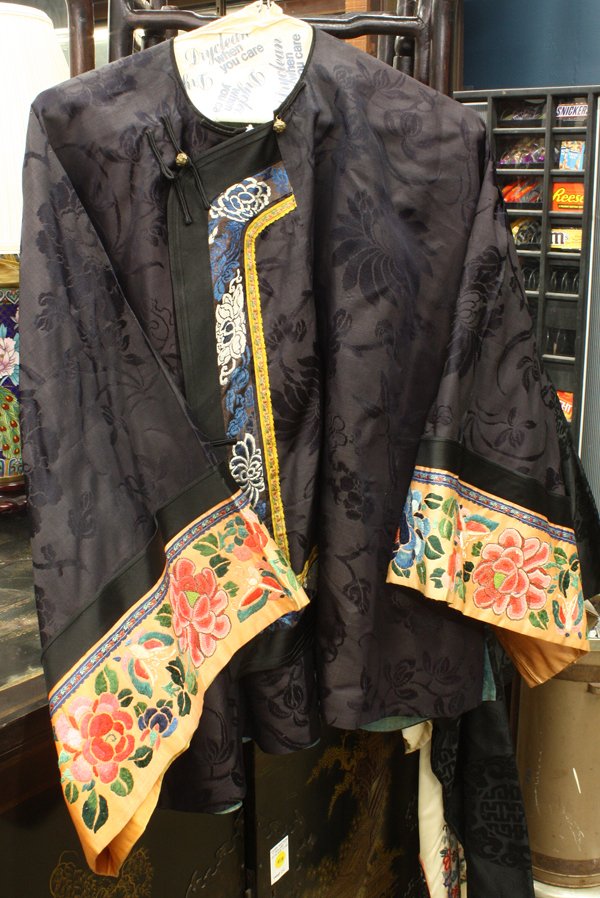 Three Chinese Silk Robes: (Lot of 3) Group of three Chinese silk robes, the first an informal man's robe with buttons down the front and fabricated from black damask with medallions and stylized tendrils; the second of deep pu