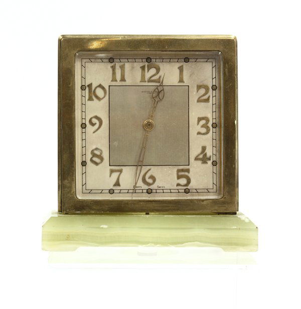 Swiss Eight Day Clock: Art Deco Swiss eight day clock in a brass and bevel two-faced glass case having raised brass Arabic chapters, joined to a green onyx base, marked Howard H. Patch LTD., 5.75''h
