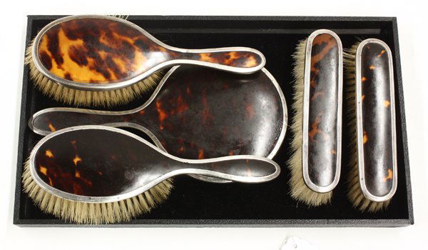 English silver five piece dresser set: (lot of 5) English tortoise shell and silver dresser set including two hairbrushes, hand mirror, two clothes brushes, by Mappin and Webb, 1920