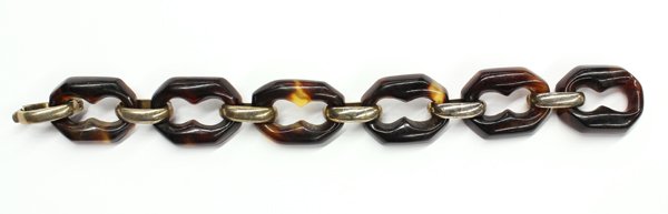 Base metal and tortoise-shell link bracelet: Tortoise shell link bracelet; mounted in gilt base metal and consisting of (6) anchor shape carved natural tortoise shell links measuring 8'' long with fold-over clasp. The bracelet weighs 28.8 grams.