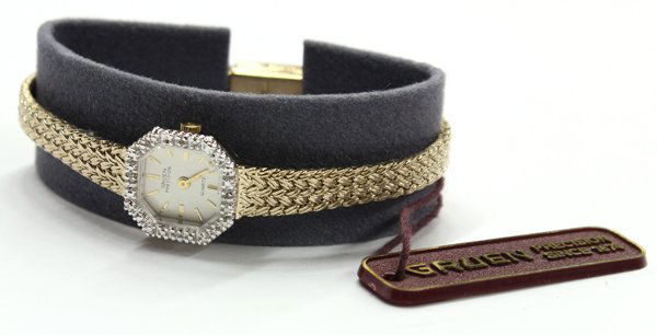 Gruen Precision quartz wristwatch: Gruen Precision wristwatch; having stainless steel back, base metal bezel, gold toned bracelet and clasp. #GR2296. (Condition: not working). Having box