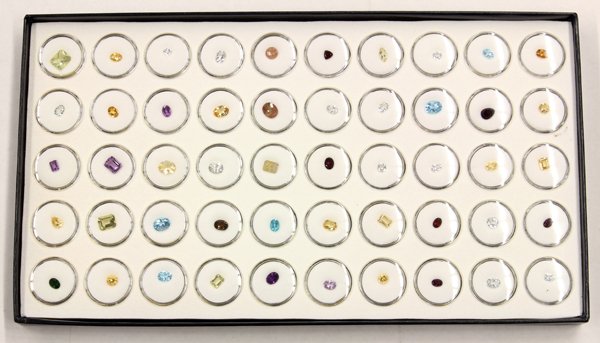 Lot of (6) trays of (300) loose gemstones: Lot of (6) trays containing (300) loose gemstones of various shapes and cuts, including; citrine, topaz, sunstone, ruby, amethyst, sapphire, smokey quartz, emerald and garnet.