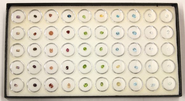 Lot of (6) trays with (300) loose gemstones.: Lot of (6) trays containing (300) loose gemstones of various shapes and sizes, including fire opal, sunstone, topaz, ametrine, citrine, peridot, iolite and garnet. Includes trays with gemstone contain