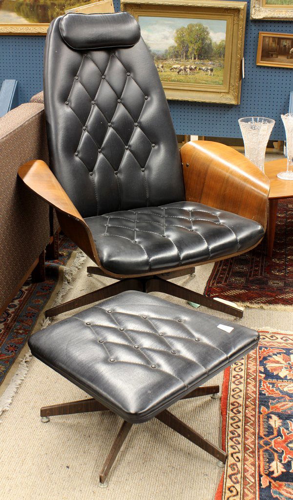 Plycraft lounge chair and ottoman: George Mulhauser for Plycraft, lounge chair and ottoman circa 1960, the chair having a laminated seat continuing to the shaped arms and covered in black vinyl, 44''h x 37.5''w x 22''d, together with a