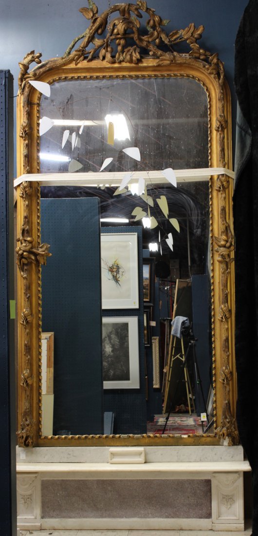 Victorian pier mirror: Victorian pier mirror circa 1860, of monumental form, the giltwood carved frame executed in the naturalistic taste, having a fruit and vine moulding flanking the single plate looking glass, rising on 