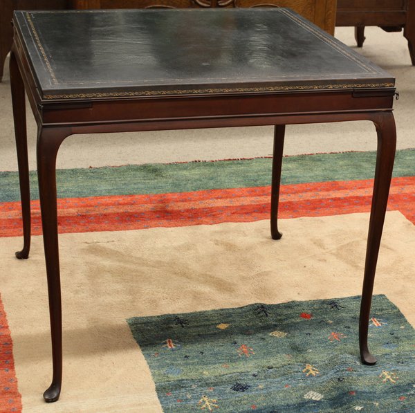 Queen Anne style games table: Queen Anne style games table, having an embossed leather top above the single drawer case with pull out corner slides and rising on cabriole legs ending on pad feet, 28.5''h x 30''w