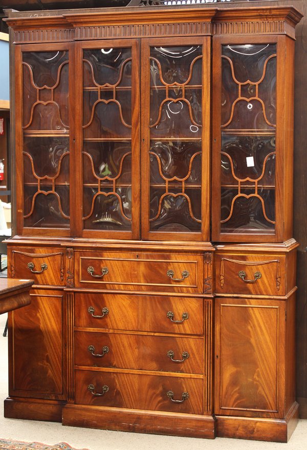 Heppelwhite style butlers secretary: Hepplewhite style breakfront secretary, executed in mahogany and having a four door superstructure with adjustable shelves, above the conforming lower case having a hinged central door opening to the 