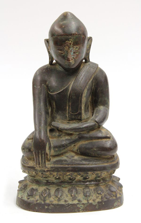 Southeast Asian Bronze Buddha: Southeast Asian bronze seated Buddha, 19th/20th century, draped in a monastic robe while in bhumisparsa mudra and seated in vajrasana, raised on a lotus pedestal, glass eyes missing, 13.5''h. Provenan