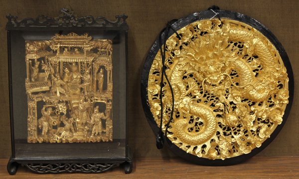 Chinese Gilt Wood Fragments: (Lot of 2) Chinese gilt decorated wood fragments, the first dynamically carved with celestial guardians and figures in the gateways of a villa, framed within a shadow box; the second, a circular plaqu