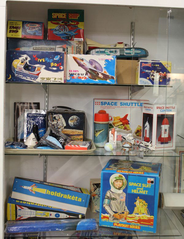space toys: (lot of 30) Collection of space related toys and memorabilia, many in original packaging including astronaut food consisting of fries, ice cream, and strawberries; space shuttle food tray and canteen,