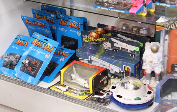 Space toys: (lot of 25) Collection of space related toys many in original packaging including NASA USA space shuttles and steel roder missle truck, battery operated rocket transporters, replica air & space ''eagl