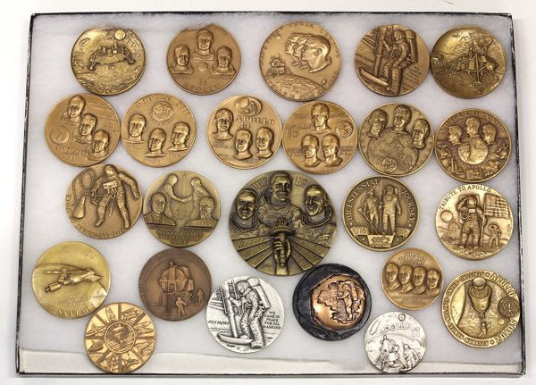Space related medallions and buckles: Collection of NASA and space exploration memorabilia mostly presented in four shadow box frames including bronze medallions, belt buckles, and watches Note: September sale will include a large collect