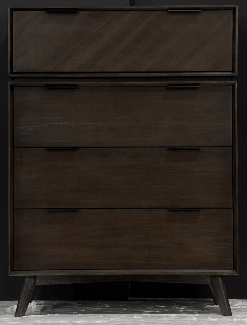 A contemporary four drawer chest with an ebonized finish and rising on splayed legs (1 of 3)