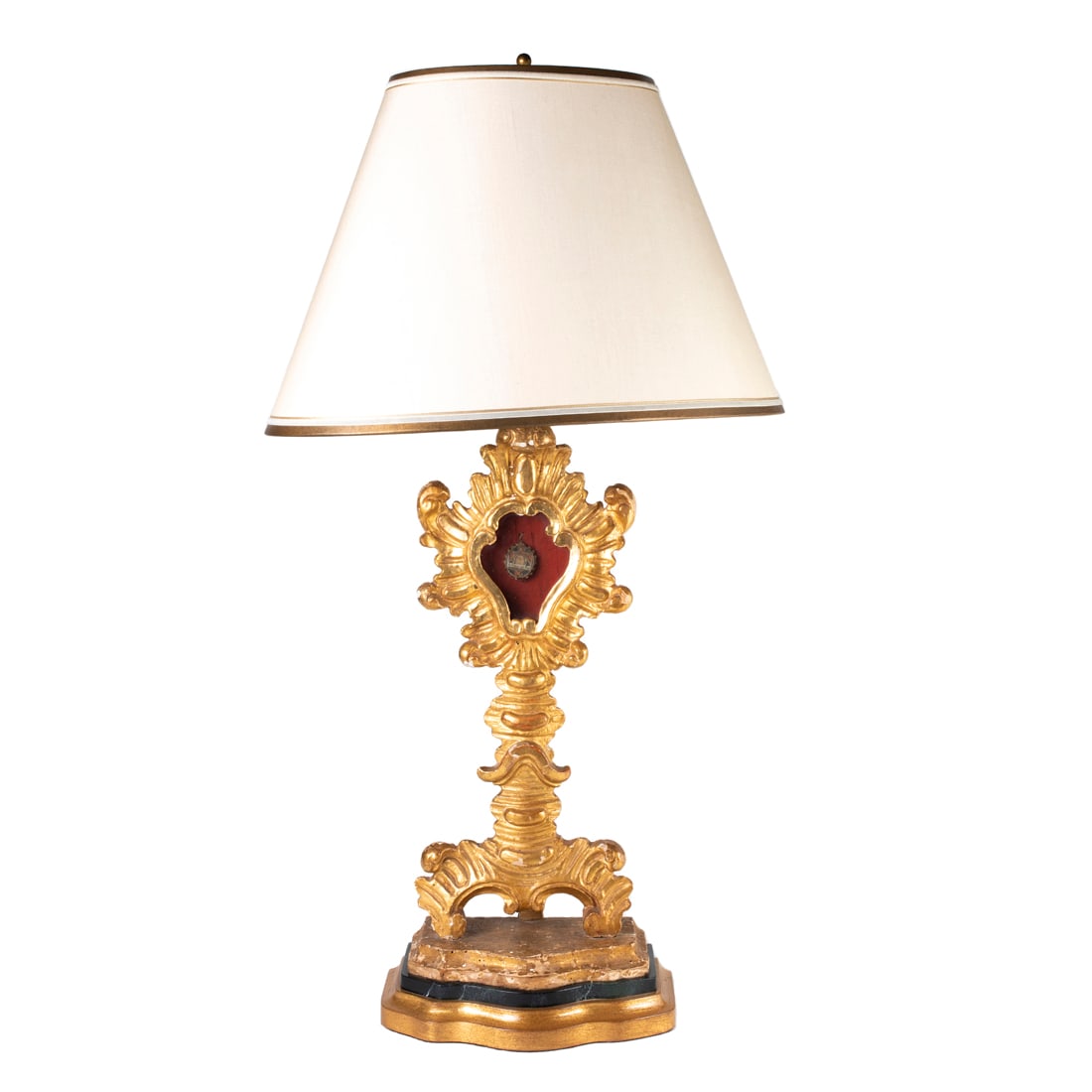 An Italian Baroque style giltwood reliquary containing bone from St. Francis Paola (1416-1507): An Italian Baroque style giltwood reliquary containing bone from St. Francis Paola (1416-1507), 19th century, the reverse sealed with wax by a Vatican cardinal, now mounted as a table lamp with later 