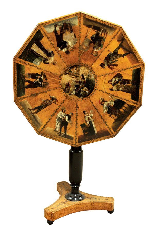 Neoclassical tilt top table: Continental Neoclassical 19th century tilt top table, the polychrome decorated and segmented top with vine and leaf borders surrounding the Classical scenic reserves, above the turned ebonized standar