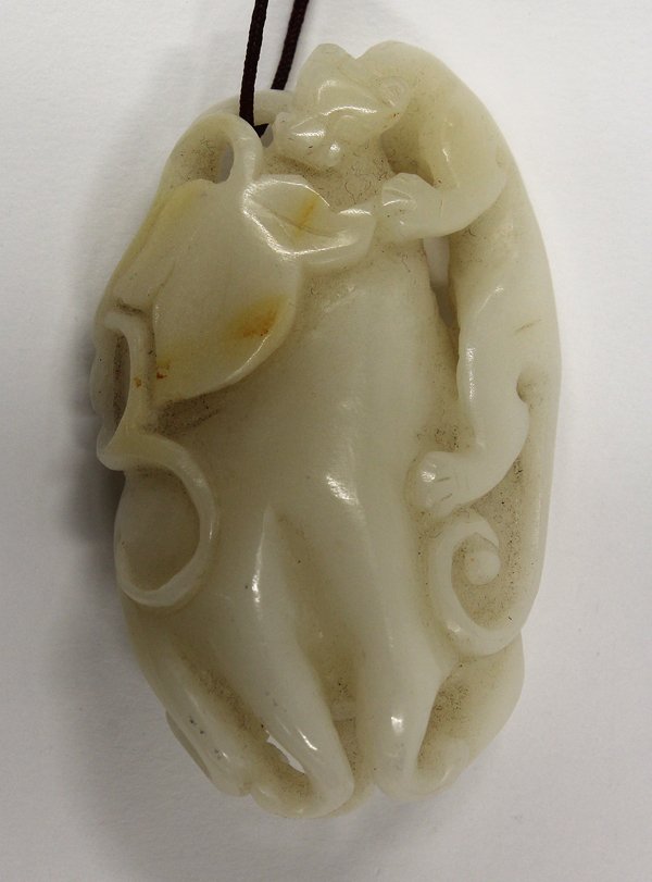 Chinese Jade/Hardstone Toggle, Chilong and Buddha: Chinese jade/hardstone toggle, of a chilong climbing onto a Buddha hand citron which is further accented by leafy tendrils, the opaque milky white matrix with minor russet splashes, 2.8''h